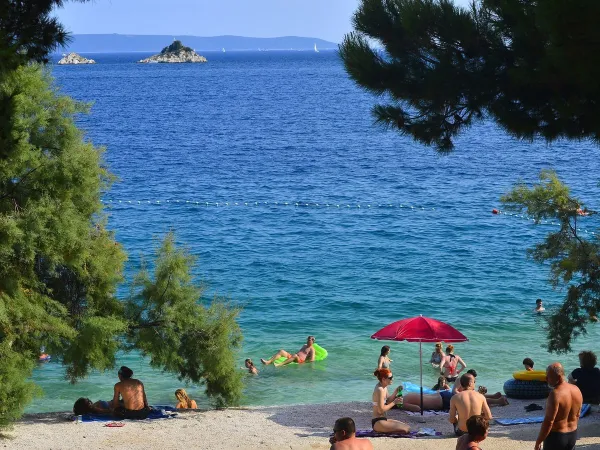 Spiaggia con mare blu al campeggio Roan Amadria Park Trogir.