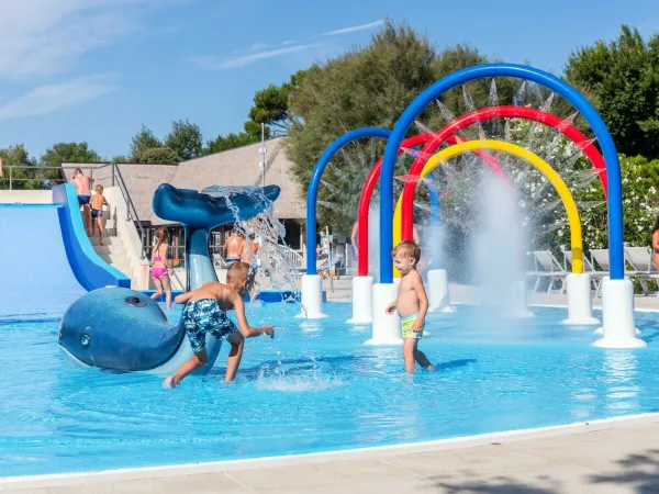 Bambini che giocano nella piscina per bambini del campeggio Roan San Francesco.