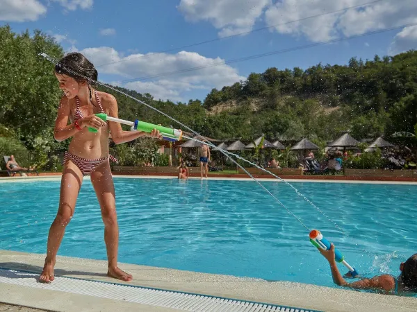 Lotta con armi ad acqua in piscina al campeggio Roan Verdon Parc.