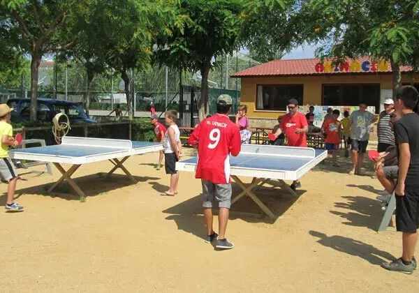 Tante persone intorno ai tavoli da ping pong del campeggio Roan La Masia.