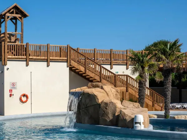 Sdraio su una piattaforma a bordo piscina al campeggio Roan Le Domaine du Clarys.